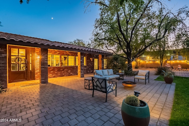 view of patio / terrace with an outdoor living space with a fire pit