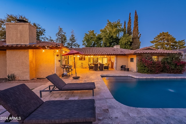 outdoor pool with a patio area