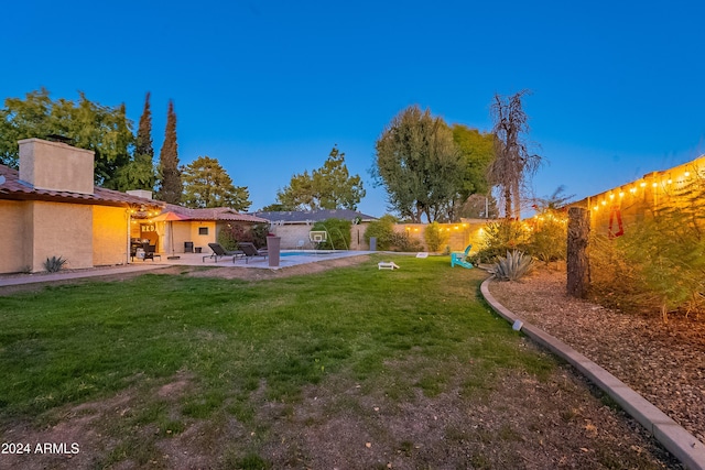 view of yard with a fenced in pool, a fenced backyard, and a patio area