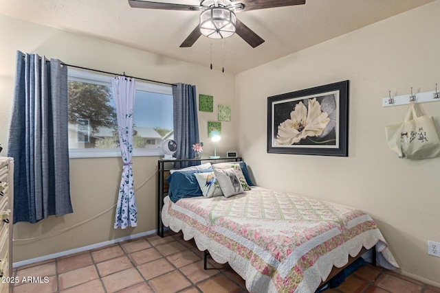 bedroom featuring baseboards, ceiling fan, and tile patterned floors
