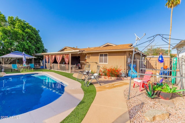 view of swimming pool with a patio, a fenced backyard, outdoor dry bar, and a fenced in pool
