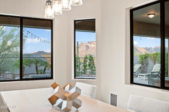 dining area featuring a mountain view and a notable chandelier