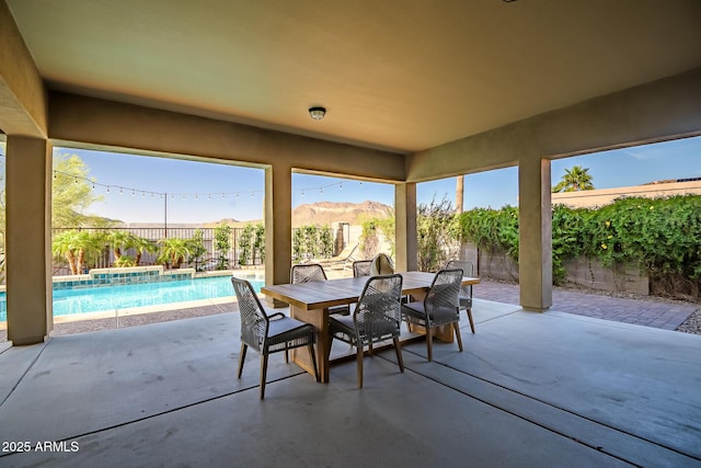 view of patio / terrace with a fenced in pool, a fenced backyard, and outdoor dining space