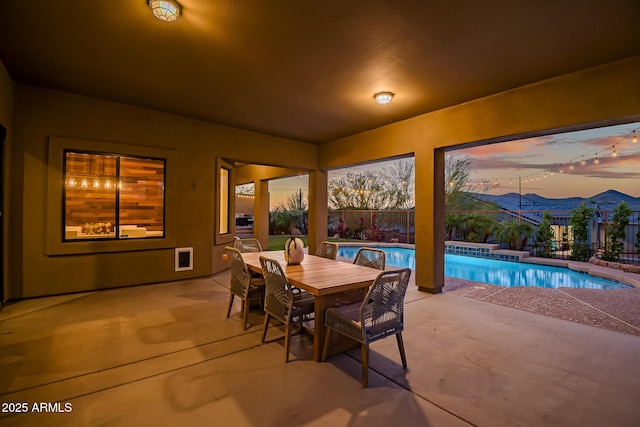 exterior space featuring a fenced in pool, fence, and outdoor dining space
