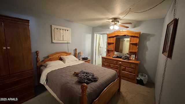 bedroom featuring ceiling fan and dark carpet