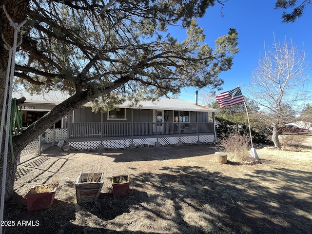 rear view of property with covered porch