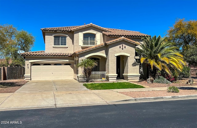 mediterranean / spanish home with a garage