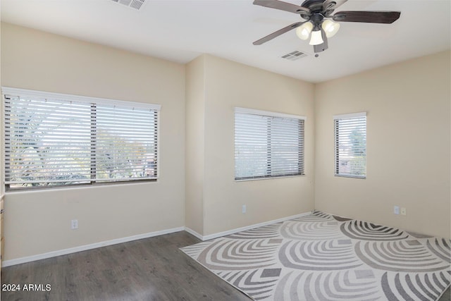 unfurnished room with dark hardwood / wood-style floors and ceiling fan