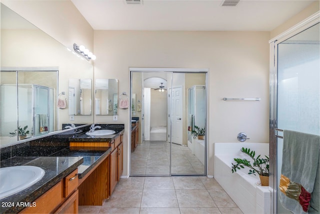 bathroom featuring tile floors, tiled tub, ceiling fan, and oversized vanity