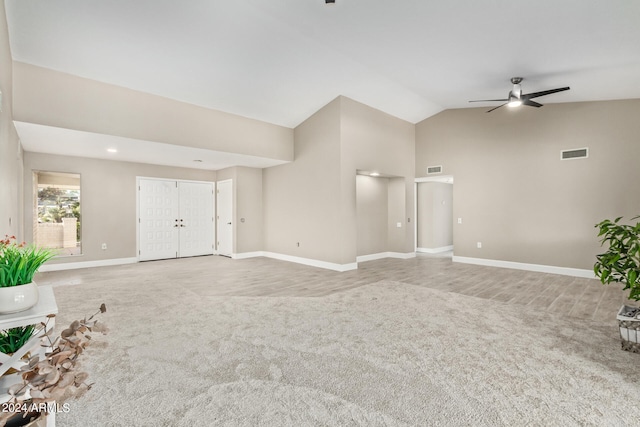 unfurnished living room with high vaulted ceiling, ceiling fan, and carpet floors