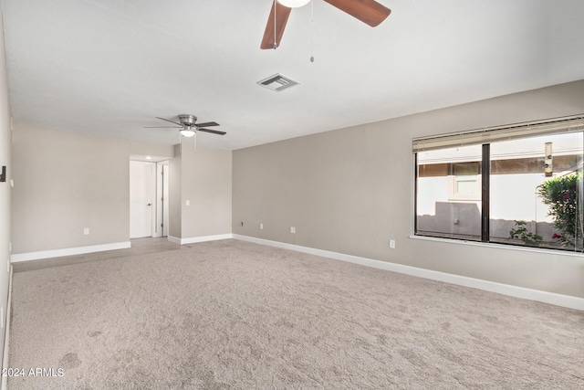 spare room with ceiling fan and carpet floors