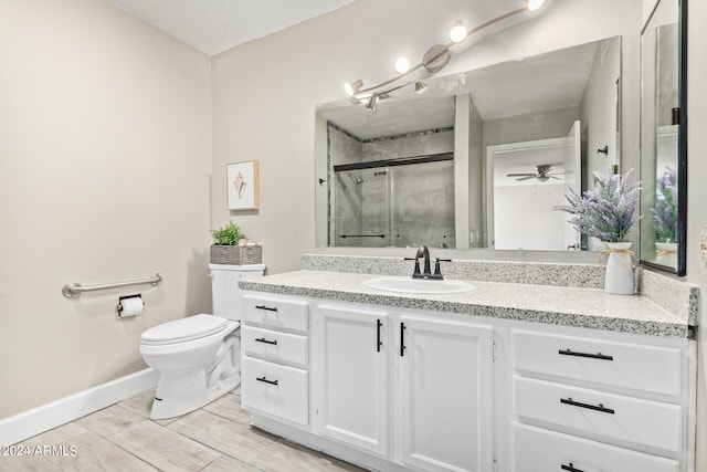 bathroom featuring oversized vanity, ceiling fan, tile floors, and toilet