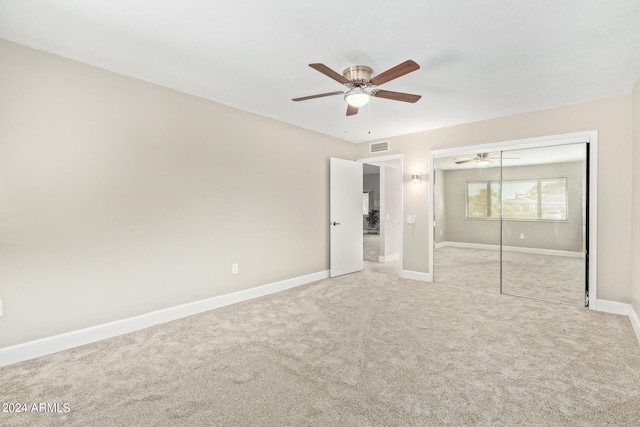 unfurnished bedroom featuring a closet, ceiling fan, and carpet