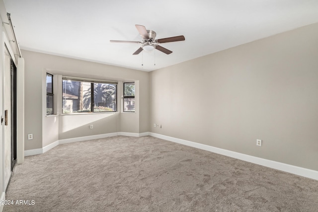 spare room with ceiling fan and carpet flooring