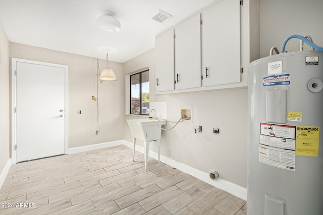 laundry area featuring light hardwood / wood-style floors, cabinets, washer hookup, and electric water heater