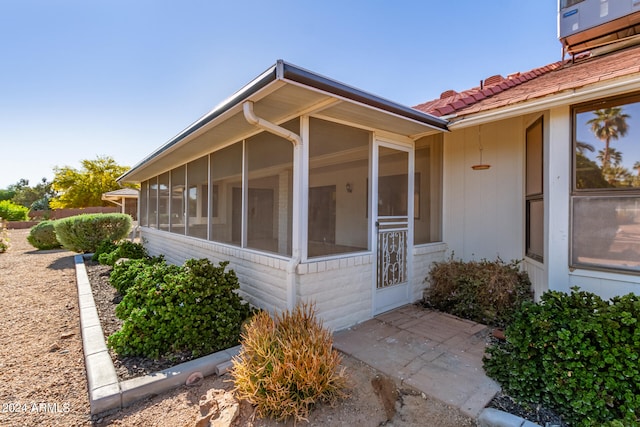 view of side of home featuring a sunroom