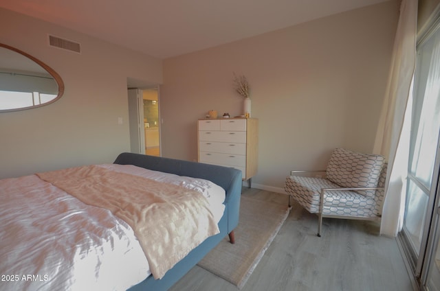 bedroom with hardwood / wood-style floors