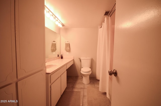 bathroom featuring vanity, tile patterned floors, and toilet