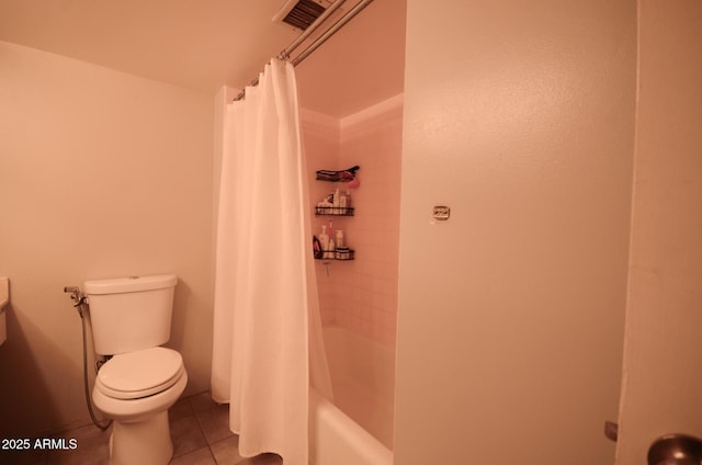 bathroom featuring tile patterned flooring, shower / tub combo with curtain, and toilet