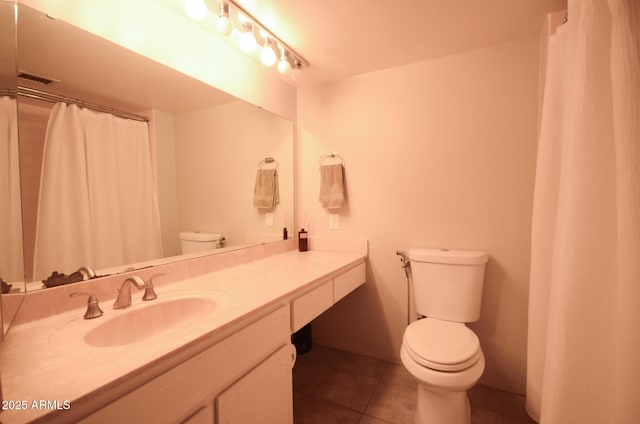 bathroom featuring vanity, toilet, and tile patterned flooring