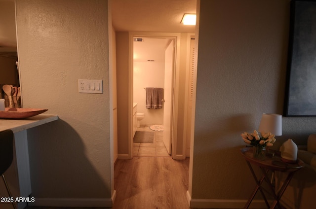 bathroom featuring hardwood / wood-style flooring and toilet