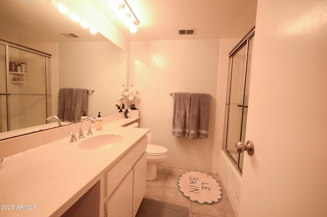 full bathroom featuring vanity, tile patterned floors, shower / bath combination with glass door, and toilet