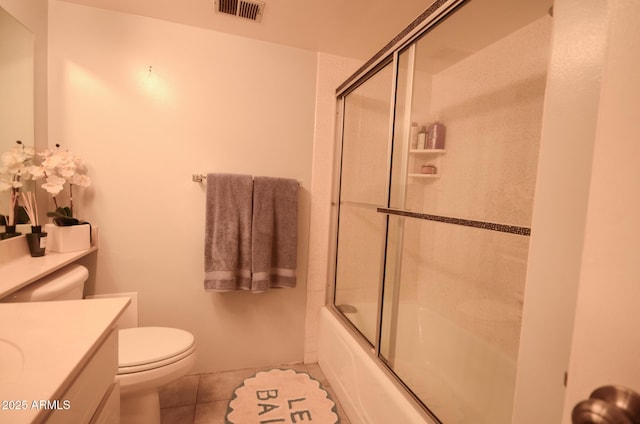 full bathroom with vanity, tile patterned floors, enclosed tub / shower combo, and toilet