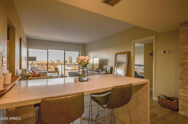 kitchen with hardwood / wood-style flooring and a breakfast bar area