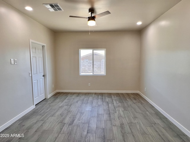 empty room featuring recessed lighting, wood finished floors, a ceiling fan, visible vents, and baseboards