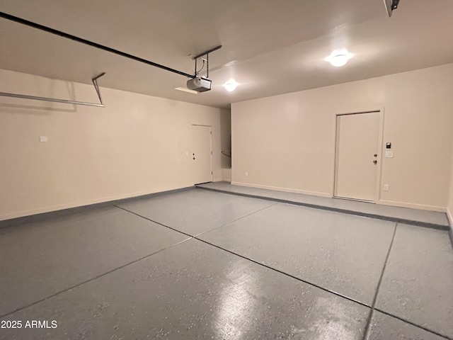 garage with baseboards and a garage door opener