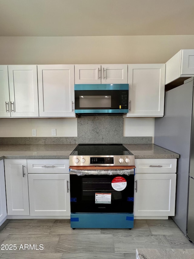 kitchen with white cabinetry and appliances with stainless steel finishes