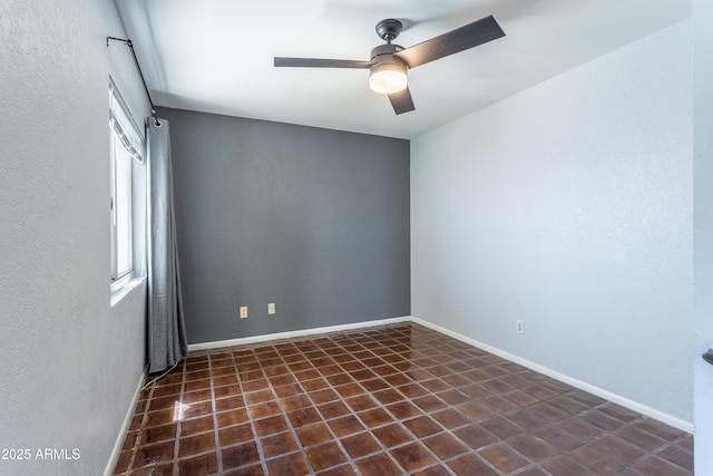 tiled spare room with a ceiling fan and a wealth of natural light