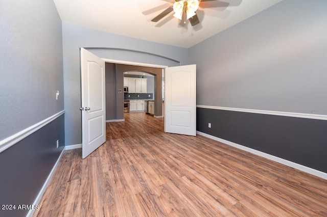 interior space featuring wood-type flooring and ceiling fan