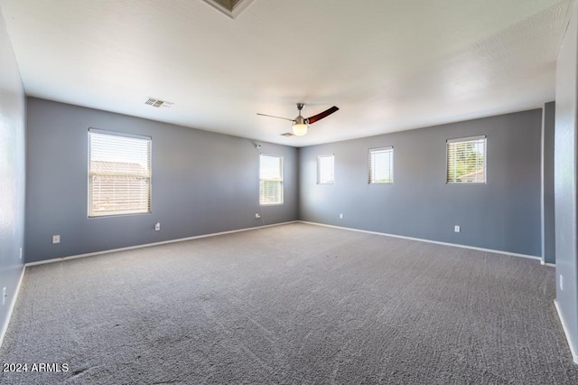 carpeted spare room featuring ceiling fan