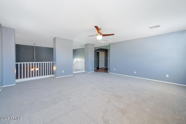 unfurnished room featuring ceiling fan and carpet