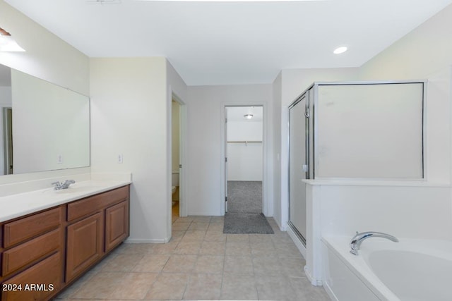 bathroom with independent shower and bath, vanity, and tile patterned floors