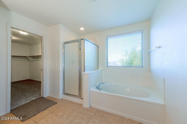 bathroom with tile patterned floors and independent shower and bath