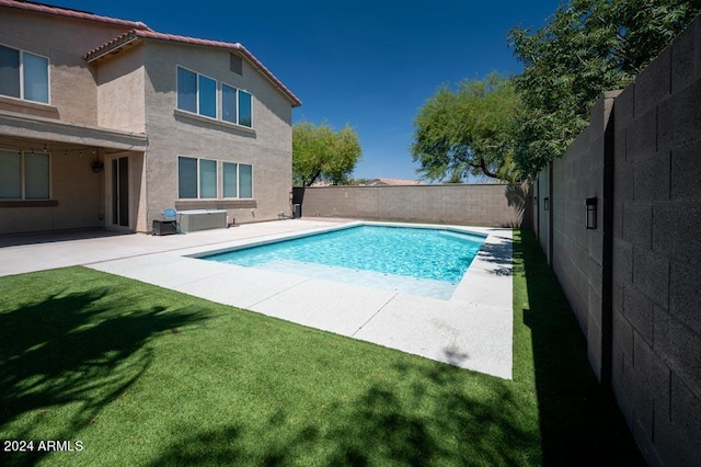 view of pool featuring a lawn and a patio