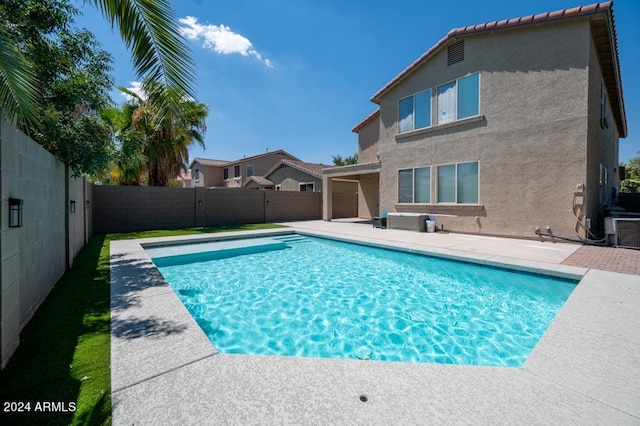 view of swimming pool featuring cooling unit and a patio