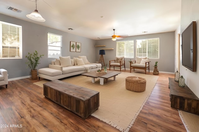 living room with hardwood / wood-style floors and ceiling fan