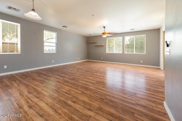 empty room featuring ceiling fan and hardwood / wood-style floors