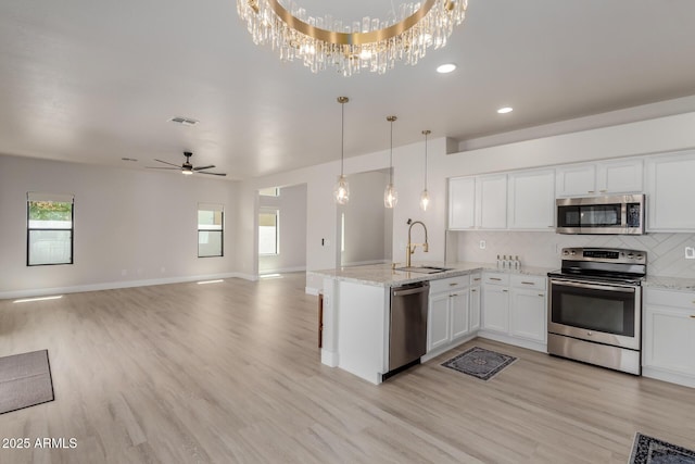 742 W Vineyard Plains Dr, San Tan Valley, AZ 85143 - kitchen with appliances with stainless steel finishes, open floor plan, light wood-type flooring, white cabinets, and recessed lighting