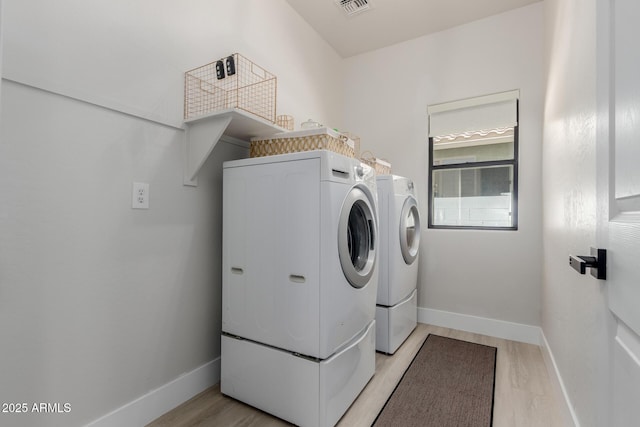 742 W Vineyard Plains Dr, San Tan Valley, AZ 85143 - washroom with washer and dryer and light wood-style flooring