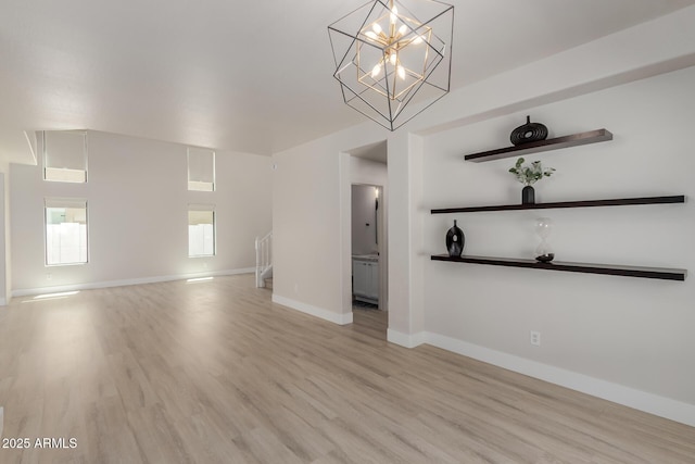 742 W Vineyard Plains Dr, San Tan Valley, AZ 85143 - unfurnished living room with light wood-type flooring and a chandelier