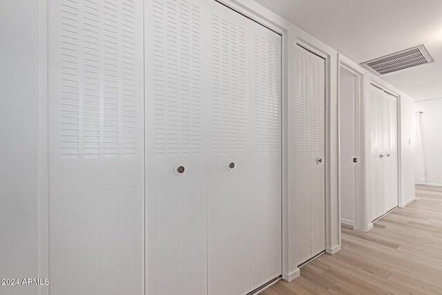 corridor with light wood-type flooring