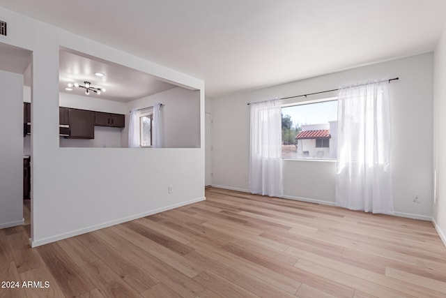 unfurnished living room featuring light wood-type flooring