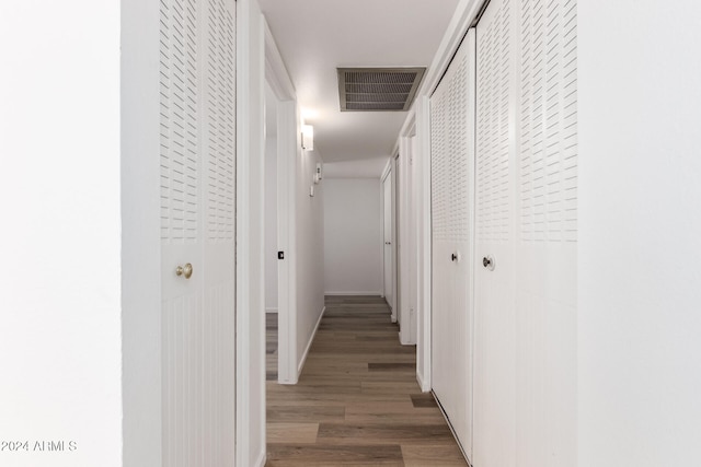 corridor with dark hardwood / wood-style floors