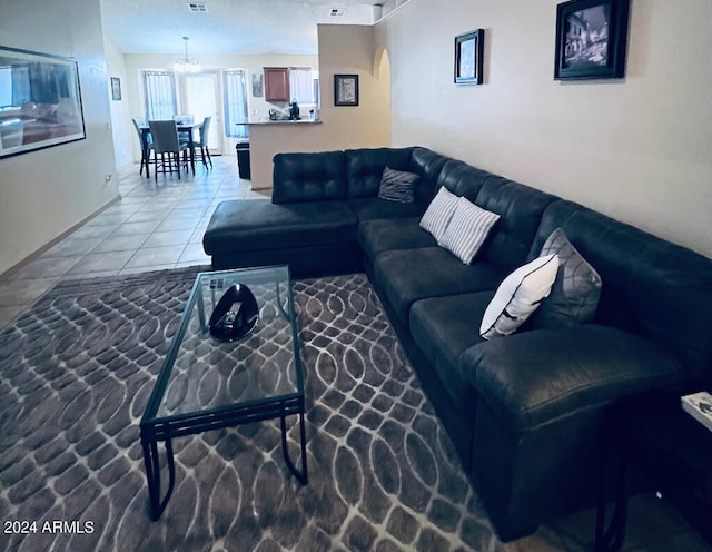 living room featuring light tile patterned floors and a chandelier