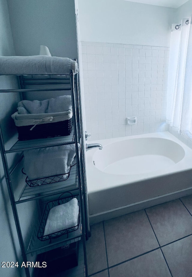 bathroom with a bathtub and tile patterned floors