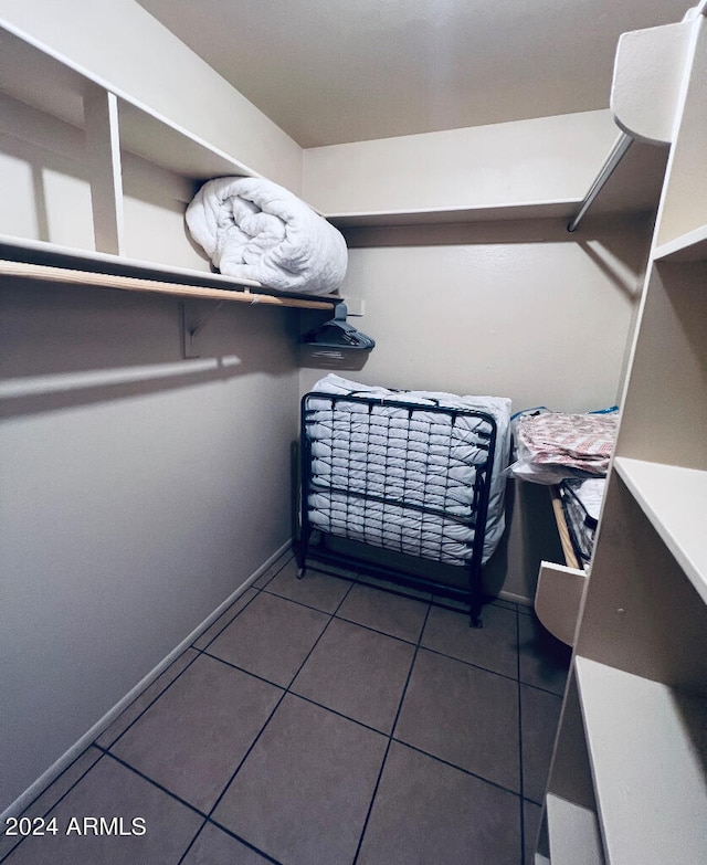 walk in closet featuring tile patterned flooring